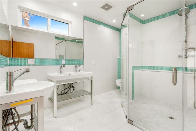 Ensuite bath off level 2 bedroom with dual sinks, and a large glass enclosed walk-in shower. | Image 32
