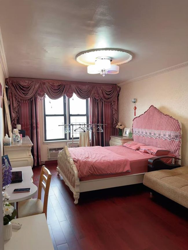 Bedroom with ornamental molding, wood finished floors, and an AC wall unit | Image 10