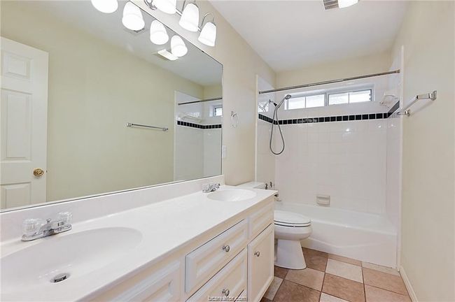 Full bath featuring toilet, double vanity, and bathtub / shower combination | Image 9