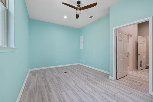 Spare room featuring a ceiling fan and wood tiled floors | Image 19