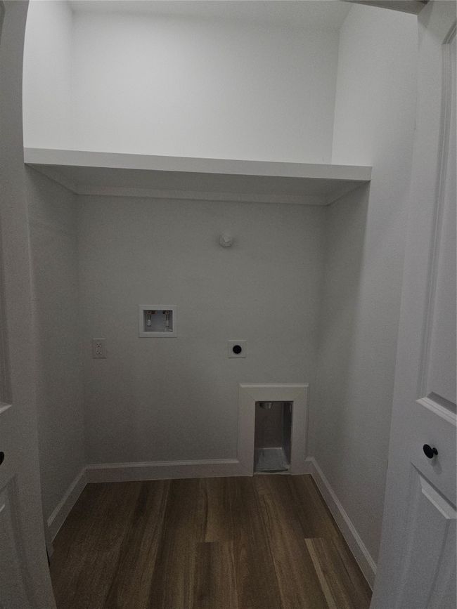 Clothes washing area with baseboards, dark wood finished floors, washer hookup, laundry area, and hookup for an electric dryer | Image 18