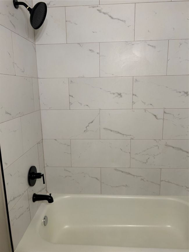 Bathroom featuring shower / tub combination | Image 25