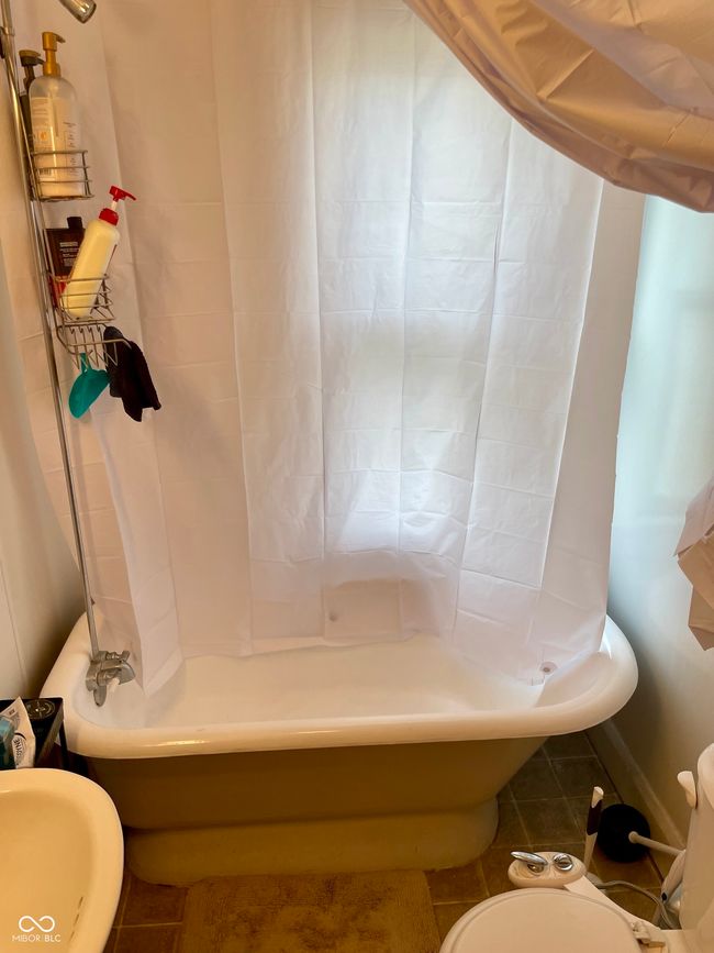 bathroom featuring toilet, tile patterned flooring, and shower / bath combination | Image 17