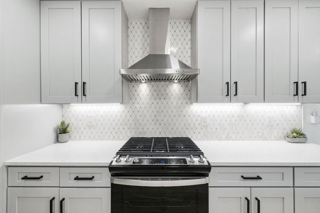 The modern vent hood gives the kitchen a modern touch. | Image 14