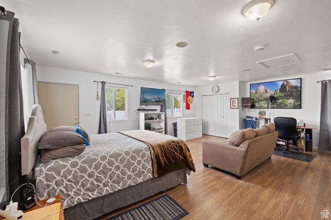 Bedroom featuring attic access, wood finished floors, and a closet | Image 40