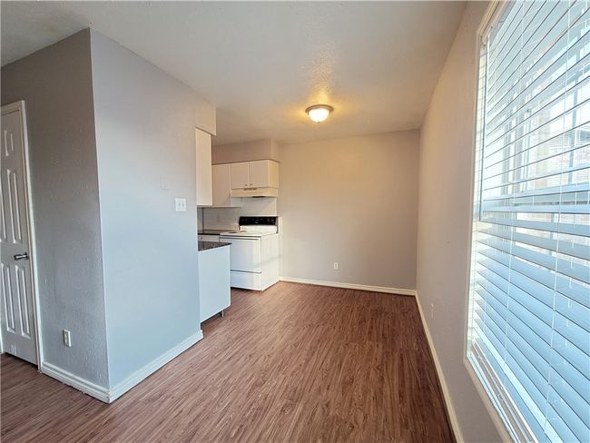 Unfurnished living room featuring dark wood-style floors and baseboards | Image 6