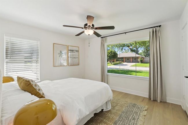 This airy secondary bedroom is flooded with bright natutal light coming through the window. | Image 22