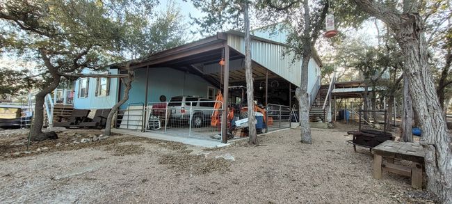 Side view of main house with oversized carport with guest apartment above. | Image 14