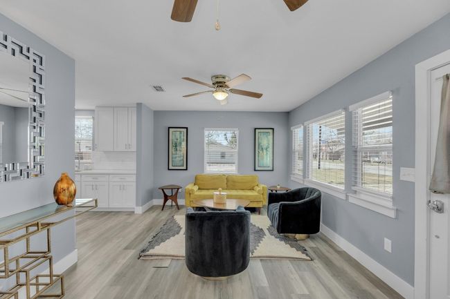 Living area with baseboards, light wood-style flooring, visible vents, and a ceiling fan | Image 7