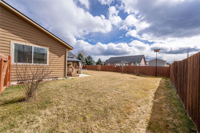 View of yard with a gazebo, a fenced backyard, and a patio area | Image 45