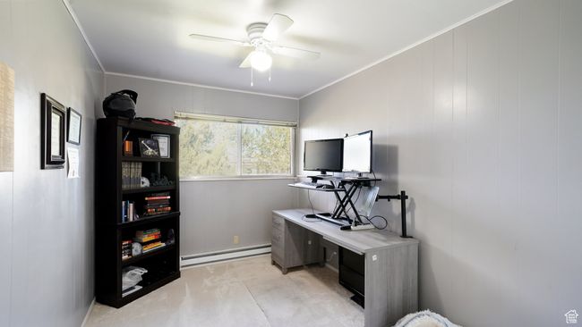 Office area featuring baseboard heating, ceiling fan, and ornamental molding | Image 13