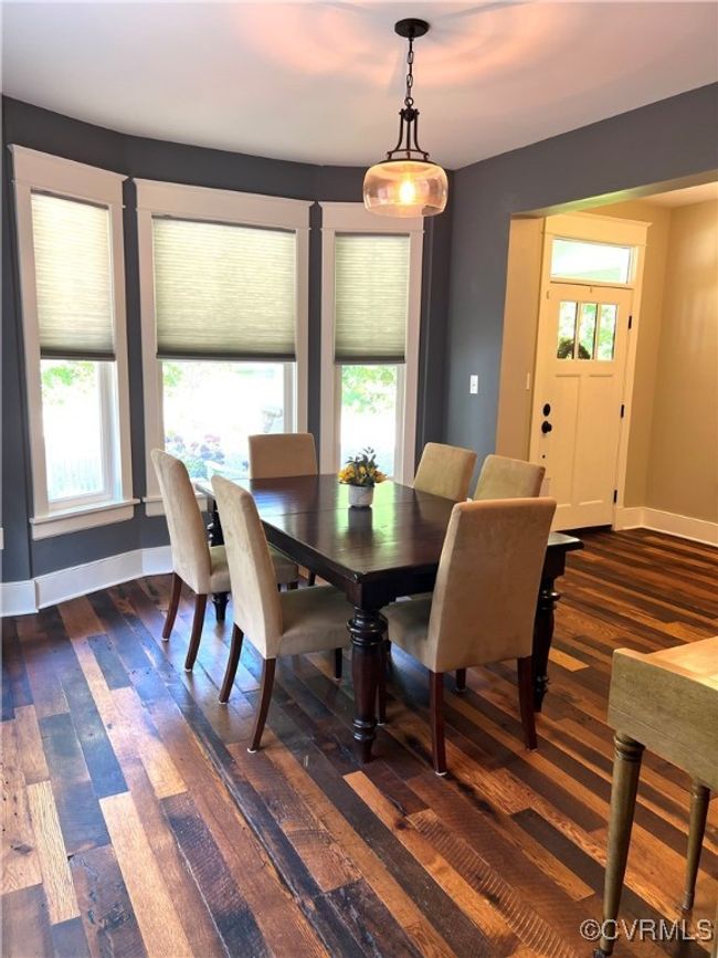 Dining space featuring healthy amount of natural light and reclaimed oak wood-style flooring | Image 9