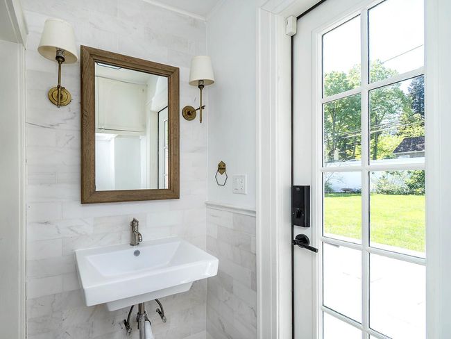 Bathroom featuring tile walls, plenty of natural light, and a sink | Image 14