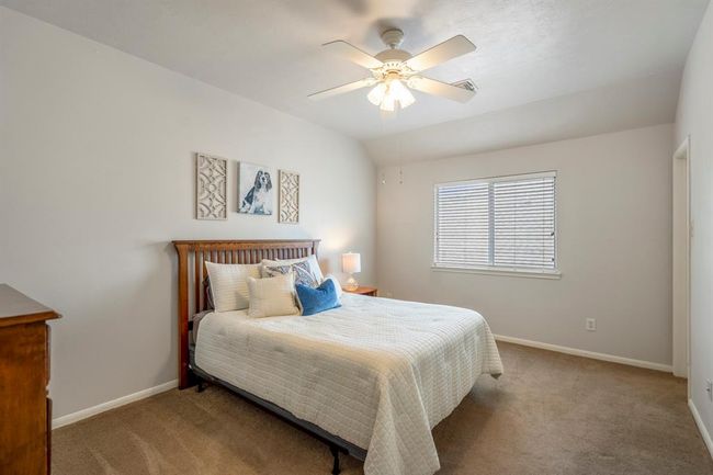 Another upstairs bedroom features a vaulted ceiling, enhancing the sense of space, along with a walk-in closet for added storage and convenience. | Image 29