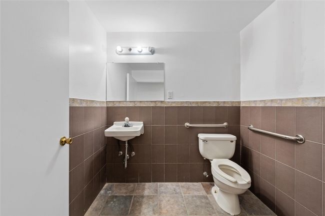 Bathroom with toilet and tile walls | Image 36