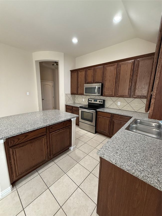 Kitchen featuring tasteful backsplash, a sink, recessed lighting, electric range, and light tile patterned flooring | Image 12