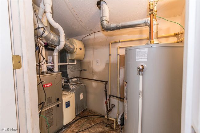 Utilities featuring gas water heater | Image 24