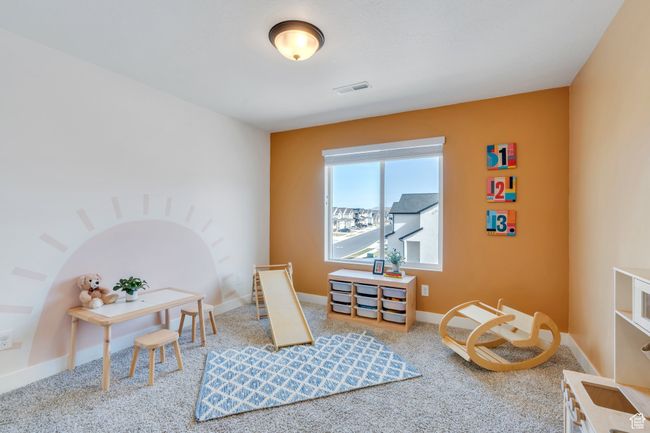 Rec room with carpet flooring, visible vents, and baseboards | Image 14