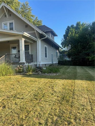 View of property exterior featuring a yard and covered porch | Image 2