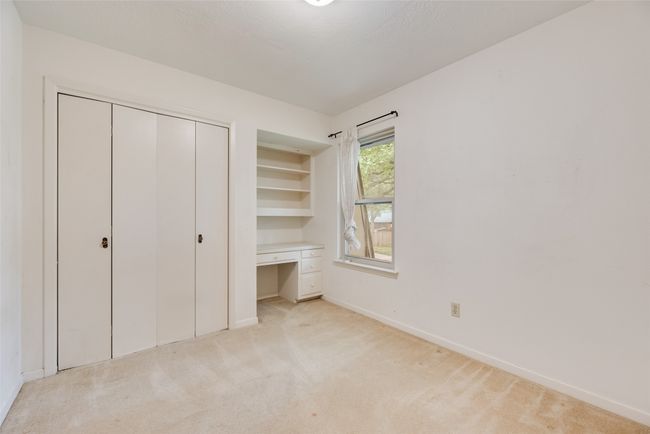 Unfurnished bedroom featuring light colored carpet, baseboards, and a closet | Image 23