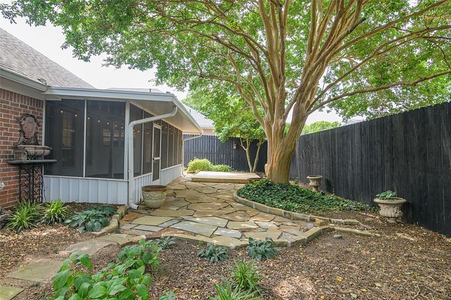 Fenced backyard featuring a sunroom and a patio area | Image 21