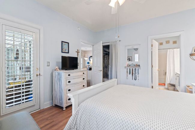 Bedroom with dark wood-style floors, baseboards, and ceiling fan | Image 22