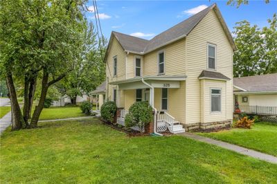 View of front property featuring a front lawn and covered porch | Image 1