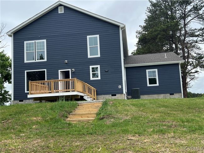 Back of house featuring a yard, a wooden deck, central air condition unit, and crawl space | Image 45