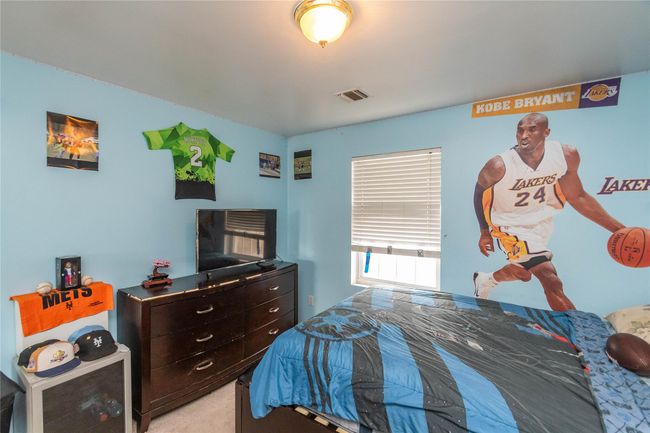 Bedroom with light colored carpet and visible vents | Image 36