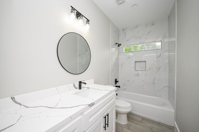 Secondary Bathroom Has Both The Stand-Up Shower & Bathtub Combination. All The Bathrooms Throughout The Home Have The Same Aesthetic Including Quartz Countertops & Mirrors | Image 15