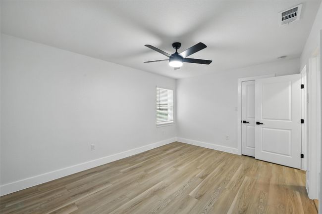Unfurnished bedroom with light wood-style floors, baseboards, and a ceiling fan | Image 33