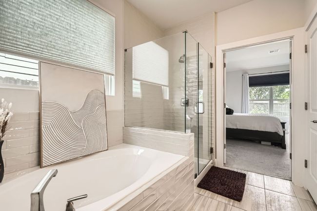 Ensuite bathroom with a bath, a shower stall, and tile patterned flooring | Image 17