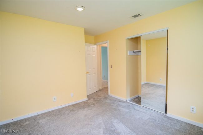 Unfurnished bedroom with carpet floors, baseboards, and a closet | Image 19