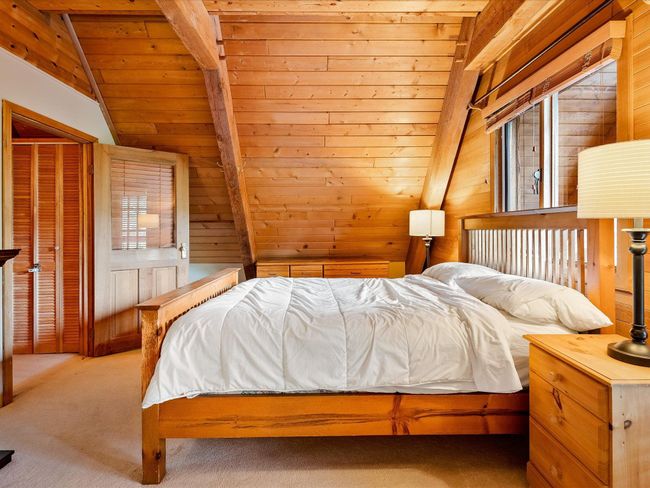 Bedroom featuring carpet floors, wood ceiling, vaulted ceiling with beams, and wooden walls | Image 21