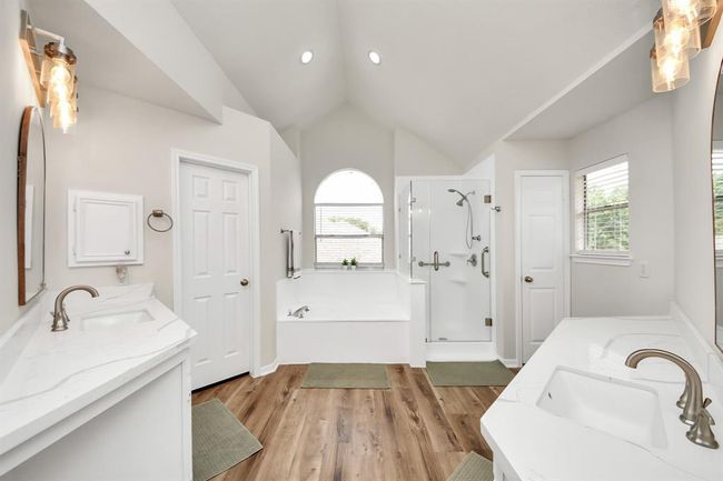 Wow! Step into the bright, clean primary ensuite, where a spacious dual-sink vanity offers plenty of room for busy mornings. With generous counter space, abundant storage, and two separate closets, this bathroom is designed to meet your daily needs with ease and style. | Image 29