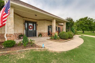 View of front facade featuring a porch and a front yard | Image 2