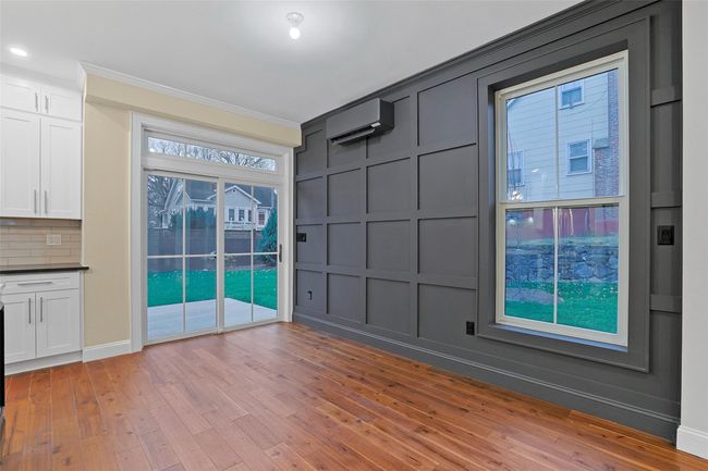 Unfurnished room with light wood-type flooring, an AC wall unit, and ornamental molding | Image 12