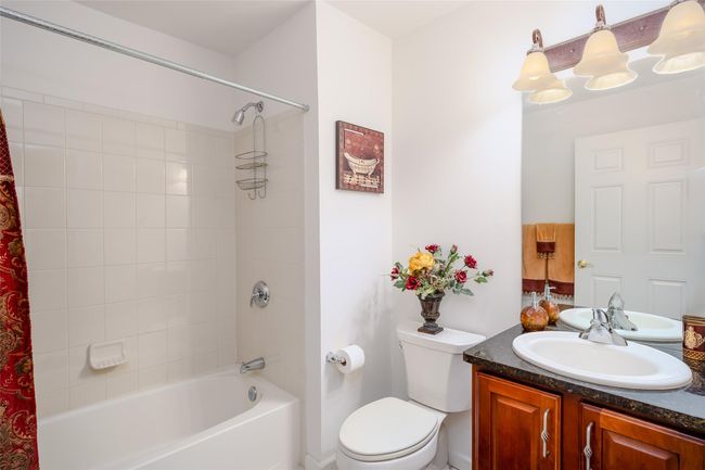 Full bathroom with shower / bathtub combination with curtain and vanity | Image 18