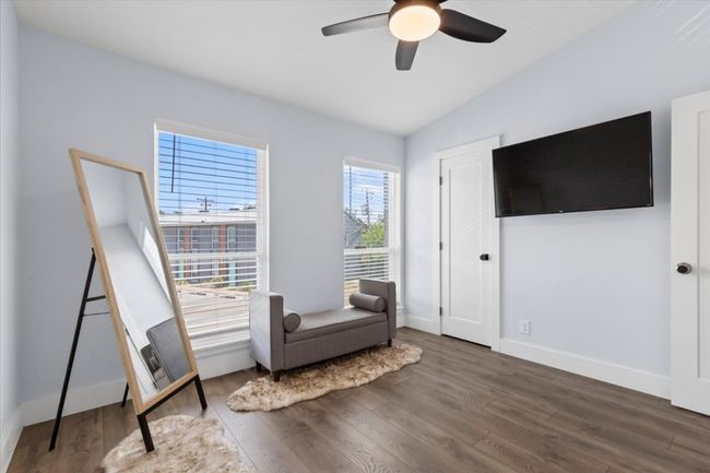 Sitting room with wood finished floors, a ceiling fan, and lofted ceiling | Image 20