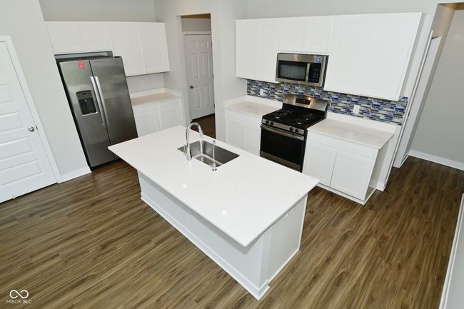 kitchen with a sink, backsplash, dark wood-style floors, and stainless steel appliances | Image 16
