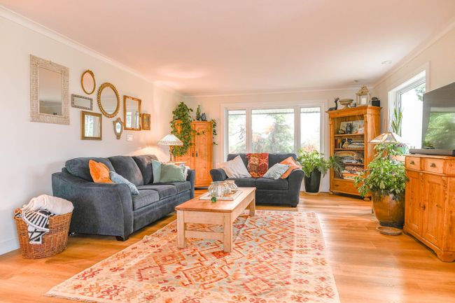 Living area featuring ornamental molding and light wood-style flooring | Image 11