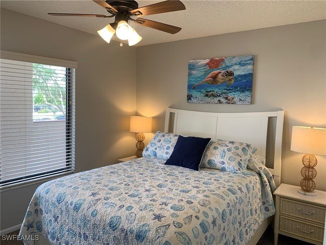 Bedroom featuring a ceiling fan, carpet, and a textured ceiling | Image 17