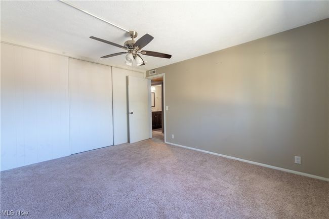 Unfurnished bedroom featuring visible vents, carpet flooring, a closet, and ceiling fan | Image 14