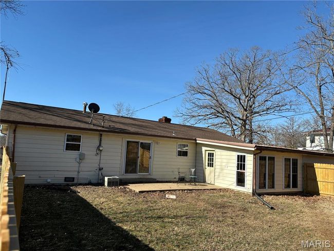 Back of house with a lawn, a patio, crawl space, fence, and central AC | Image 5