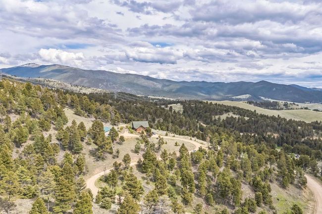 View of mountain backdrop with a heavily wooded area | Image 14
