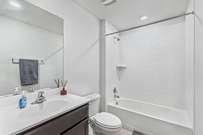 Bathroom featuring vanity and shower / tub combination | Image 14