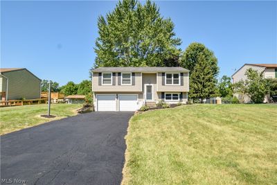 Raised ranch featuring a garage and a front yard | Image 1