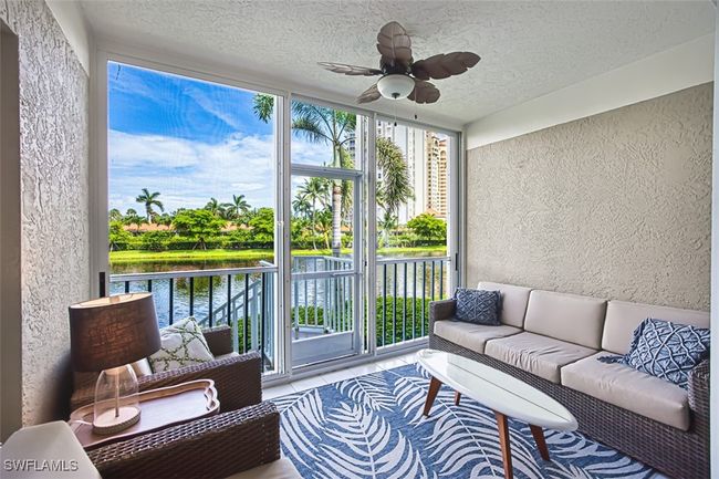 Sunroom with a water view, ceiling fan, and an outdoor hangout area | Image 20