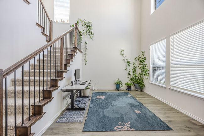 Foyer entrance featuring a towering ceiling, wood finished floors, and stairs | Image 5