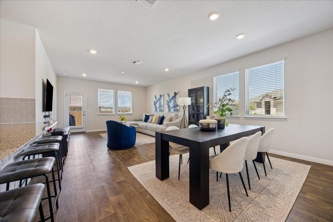 Dining area with dark wood-style flooring and recessed lighting | Image 9